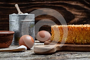 Homemade sponge cake with ingredients on wooden table. Bakery background concept. banner, menu recipe place for text, top view