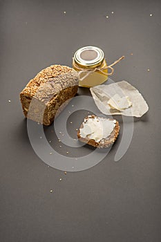 Homemade square bread made from gluten-free flour with sesame seeds. piece of bread with butter and bee honey. Close-up. concept