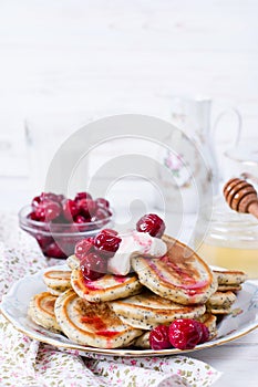 Homemade stack of pancakes with cherries for tasty healthy breakfast