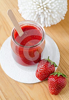 Homemade strawberry face mask in a glass jar. Natural beauty treatment and spa