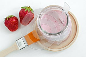 Homemade strawberry and greek yogurt face mask in a glass jar. Diy cosmetics. Top view, copy space.