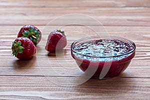 Homemade strawberry jam with fresh ripe strawberries photo