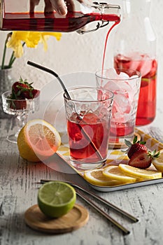 Homemade strawberry lemonade and slashing ice cubes