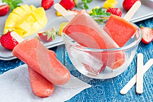 Homemade strawberry-mango popsicles