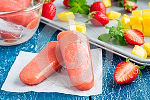 Homemade strawberry-mango popsicles