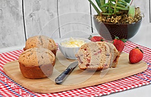Homemade strawberry muffins, cut and whole, with fresh strawberries. Copy space