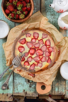 Homemade strawberry pie in baking paper with vintage forks