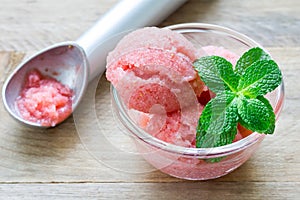 Homemade strawberry sorbet in glass and ice cream spoon photo