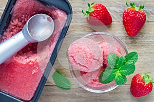 Homemade strawberry sorbet on a wooden table photo