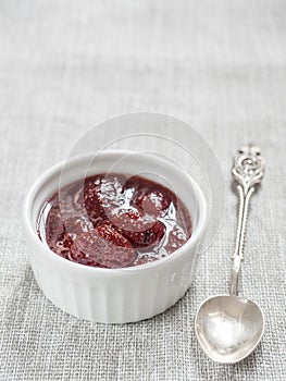 Homemade strawberry sweet delicious jam with whole berries on white background