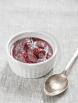 Homemade strawberry sweet delicious jam with whole berries on white background