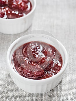 Homemade strawberry sweet delicious jam with whole berries on white background