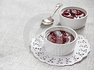 Homemade strawberry sweet delicious jam with whole berries on white background