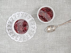 Homemade strawberry sweet delicious jam with whole berries on white background. Top view