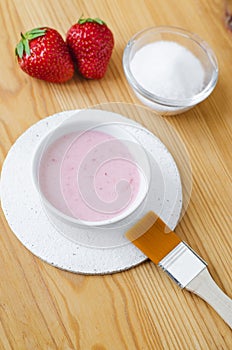 Homemade strawberry and yogurt face or eye mask in a small white bowl. Natural beauty treatment and spa