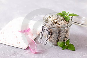 Homemade sugar scrub with chopped mint leaves and body brush. Natural beauty treatments