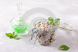 Homemade sugar scrub with chopped mint leaves and essential mint