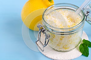 Homemade sugar scrub with olive oil, essential lemon oil and lemon peel. Diy cosmetics. Copy space.