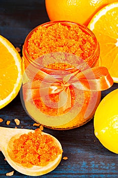 Homemade sugar scrub with Orange on a wooden background