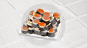 Homemade sushi with red caviar on white s
