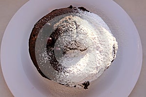Homemade sweet cholocate cake with powdered sugar and berrys served for coffee top view