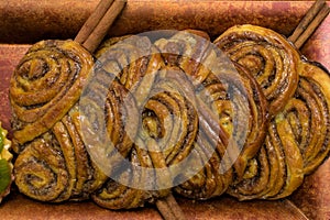 homemade sweet cinnamon rolls with sticks of cinnamons. Deserts.