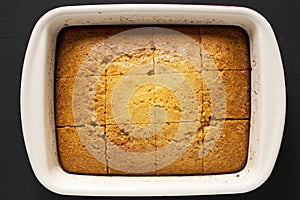Homemade sweet Cornbread Ready to Eat on a black background, top view. Flat lay, overhead, from above. Closeup
