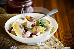 Homemade sweet dumplings with berries and sour cream