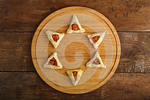 Homemade sweet gometashi cookies for Purim laid out on a board in the form of Magen David.