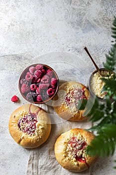 Homemade Sweet Yeast Buns filled with Berry and with crumble. Concrete bsckground