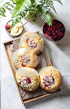 Homemade Sweet Yeast Buns filled with Berry and with crumble. Concrete bsckground