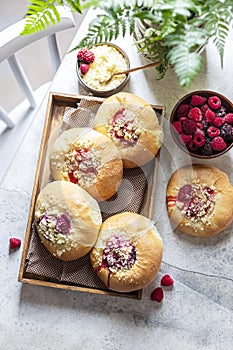 Homemade Sweet Yeast Buns filled with Berry and with crumble. Concrete bsckground