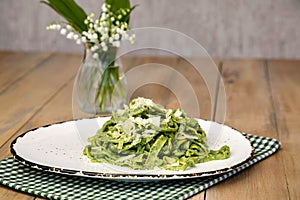Homemade tagliatelle with wild garlic are fresh homemade pasta made in a rustic style. photo