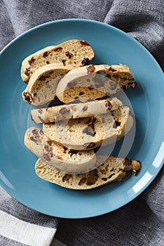 Homemade tasty Italian biscotti or cantucci in blue plate top view
