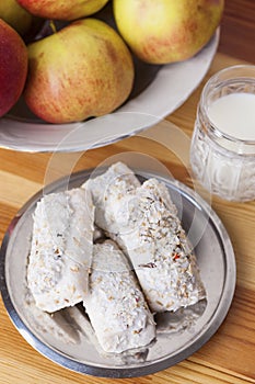 Homemade Tasty Milk Cookies with Cream Dressings and Condensed Milk Filling against of Glass of Milk on Wooden Background