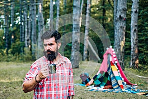 Homemade tent - hut. Handsome bearded man having fun in adventure Park.