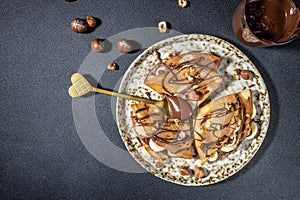Homemade thin crepes with chocolate spread, banana and hazelnuts. breakfast or dessert. banner, menu, recipe place for text, top