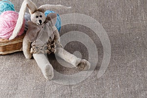 Homemade tilda doll and colored clew in backed