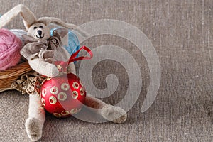 Homemade tilda doll and colored clew in backed