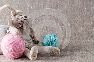 Homemade tilda doll and colored clew in backed