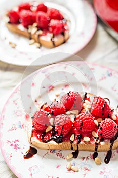 Homemade Toasts with Goat Cheese, Raspberries, Balsamic Cream and Pine Nuts