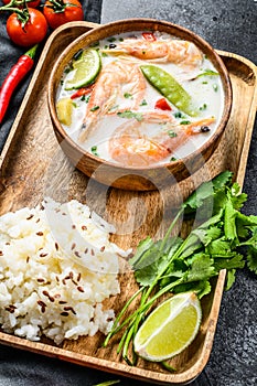 Homemade Tom Kha Gai. Coconut Milk soup in a bowl. Thai food. Black background. Top view