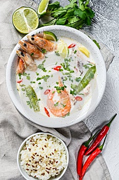 Homemade Tom Kha Gai. Coconut Milk soup in a bowl. Thai food. gray background. Top view