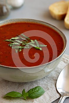 Homemade Tomato Basil Soup in a Bowl, low angle view. Close-up