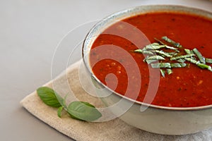 Homemade Tomato Basil Soup in a Bowl, low angle view. Close-up. Copy space