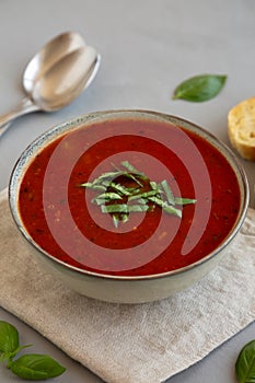 Homemade Tomato Basil Soup in a Bowl, side view. Close-up