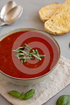 Homemade Tomato Basil Soup in a Bowl, side view. Close-up