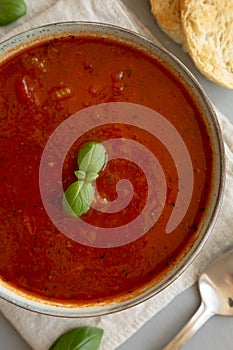 Homemade Tomato Basil Soup in a Bowl, top view. Flat lay, overhead, from above. Close-up