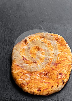 Homemade tomato and garlic flatbread on stone backgrouond