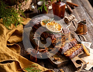 Homemade traditional christmas fruit cake cut on slices with fruits, nuts, dried citrus